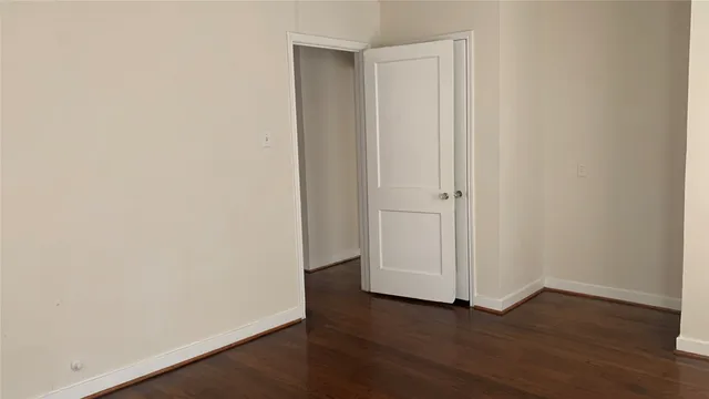 an empty room with wooden floor