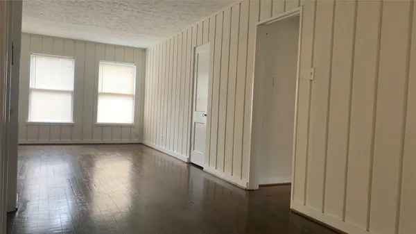 a view of a livingroom with wooden floor and a window