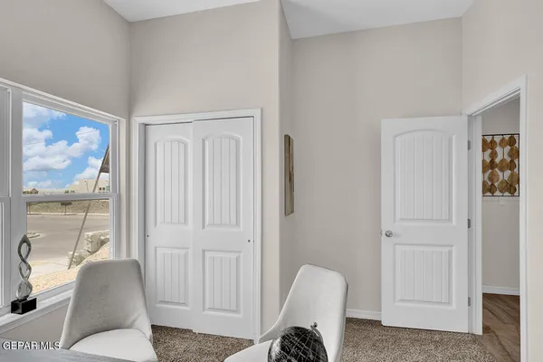 a bedroom with a bed and glass door
