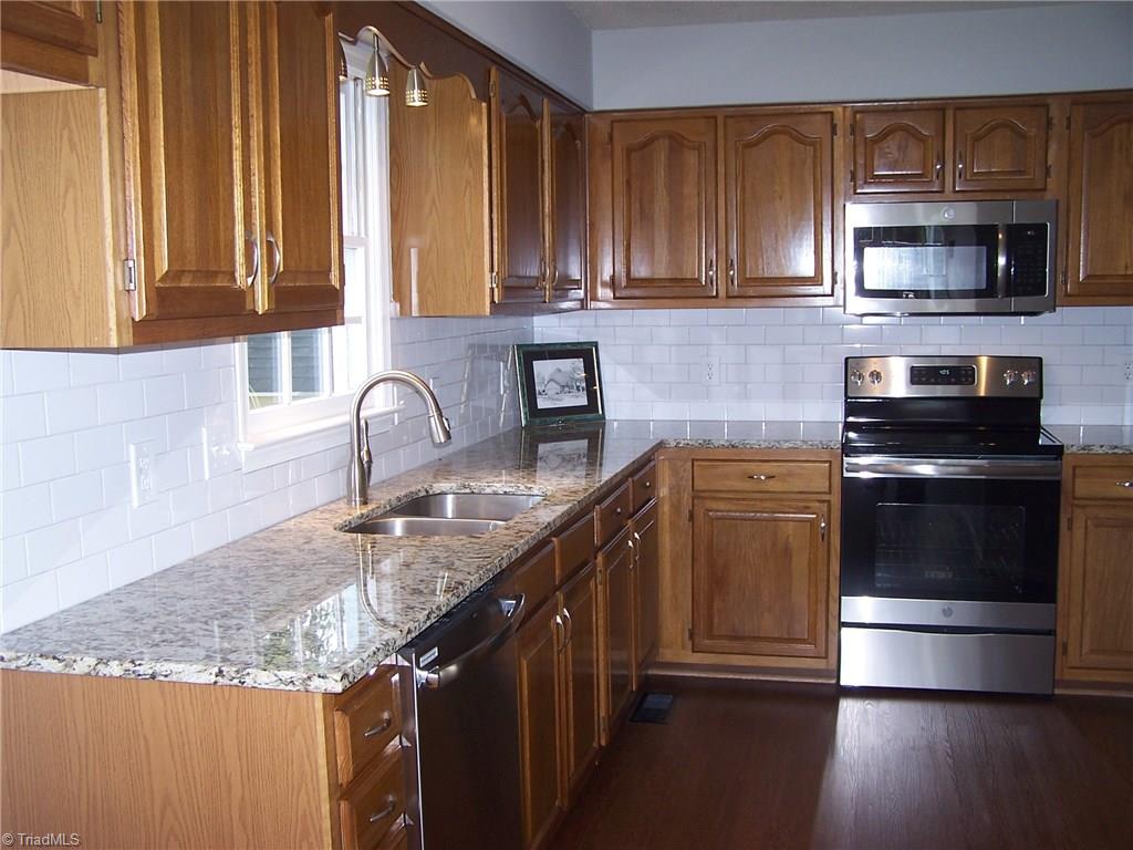 5902 High View Road Greensboro, NC 27410 - Photo 14 of 30 New subway tile with new granite countertop and SS DW, Range, MW