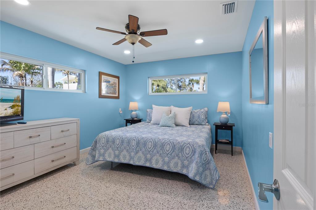 204 29th Street Holmes Beach, FL 34217 - Photo 16 of 38 a bedroom with a bed and a chandelier