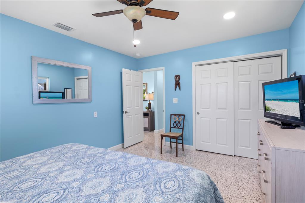 204 29th Street Holmes Beach, FL 34217 - Photo 18 of 38 a bedroom with a bed and a television in it