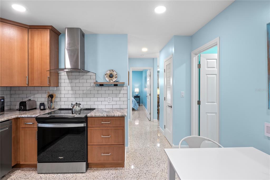 204 29th Street Holmes Beach, FL 34217 - Photo 22 of 38 a kitchen with a sink and a stove top oven