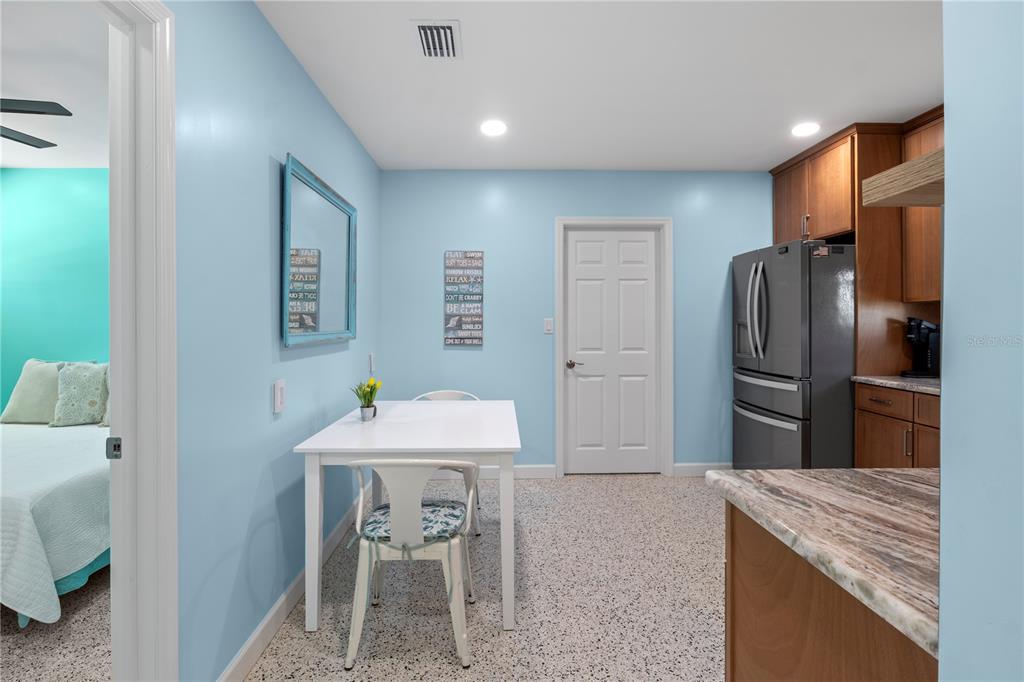 204 29th Street Holmes Beach, FL 34217 - Photo 23 of 38 a kitchen with stainless steel appliances kitchen island granite countertop a refrigerator and a sink
