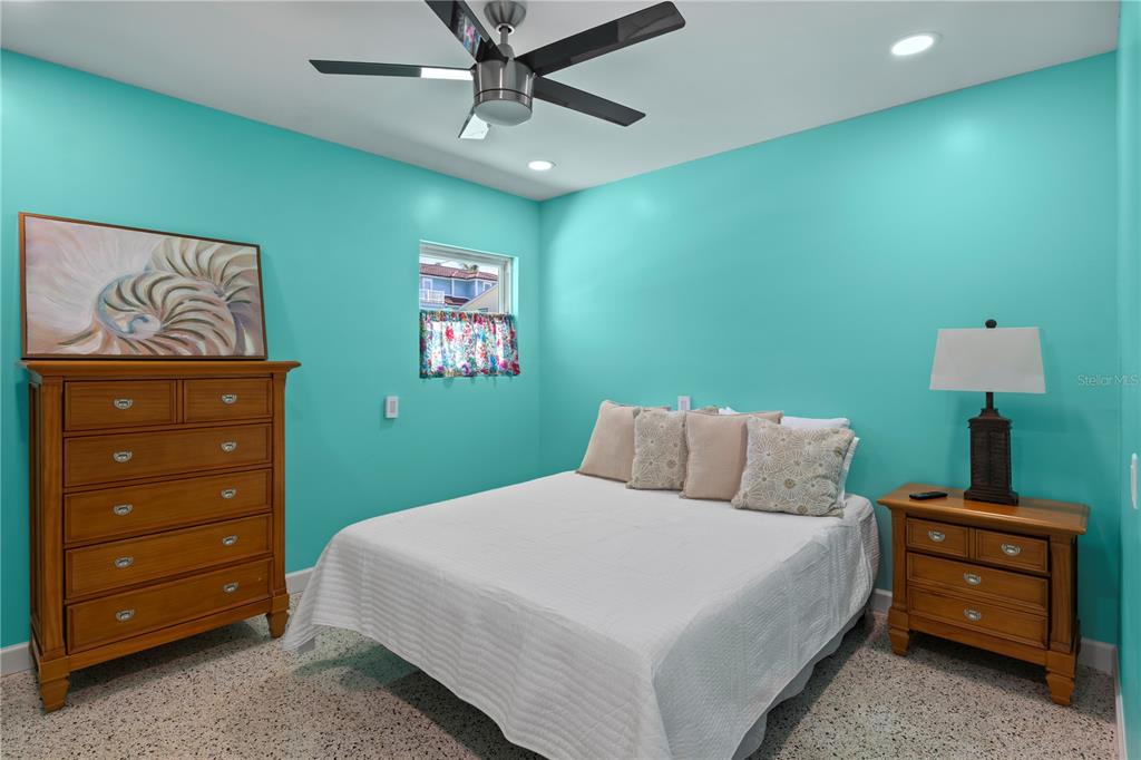 204 29th Street Holmes Beach, FL 34217 - Photo 25 of 38 a bedroom with a bed and a dresser
