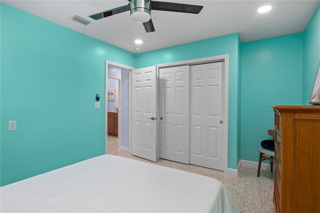 204 29th Street Holmes Beach, FL 34217 - Photo 26 of 38 a bedroom with a bed and a chandelier