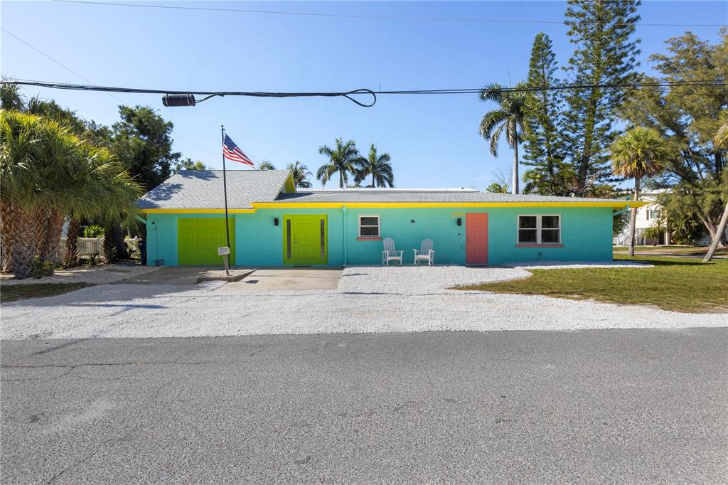 204 29th Street Holmes Beach, FL 34217 - Photo 5 of 38 front view of a house next to a yard