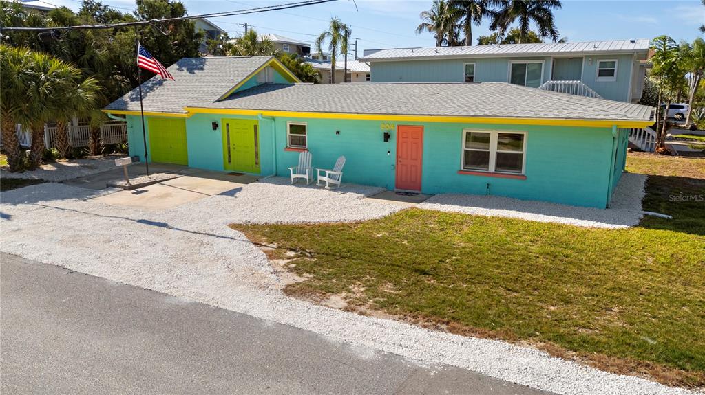 204 29th Street Holmes Beach, FL 34217 - Photo 7 of 38 a front view of a house with a yard