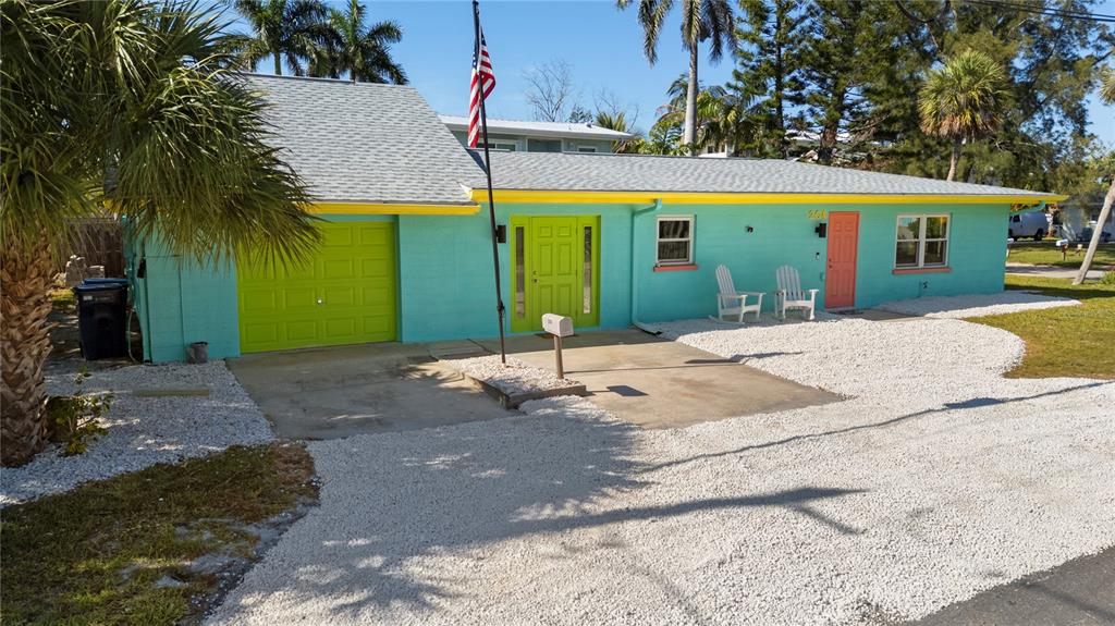 204 29th Street Holmes Beach, FL 34217 - Photo 8 of 38 a front view of a house with garden