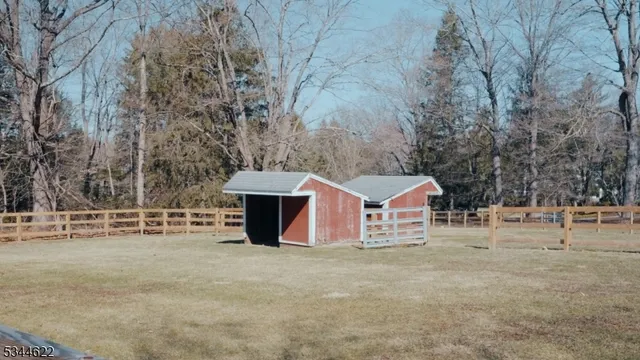 a view of a house with large trees