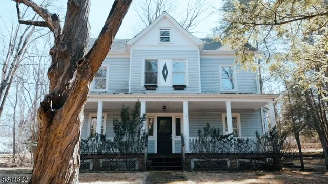 a view of a house with snow on the road
