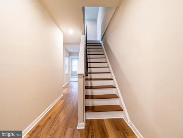 a view of hallway with wooden floor