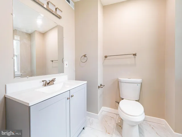 a view of empty room with wooden floor and entryway