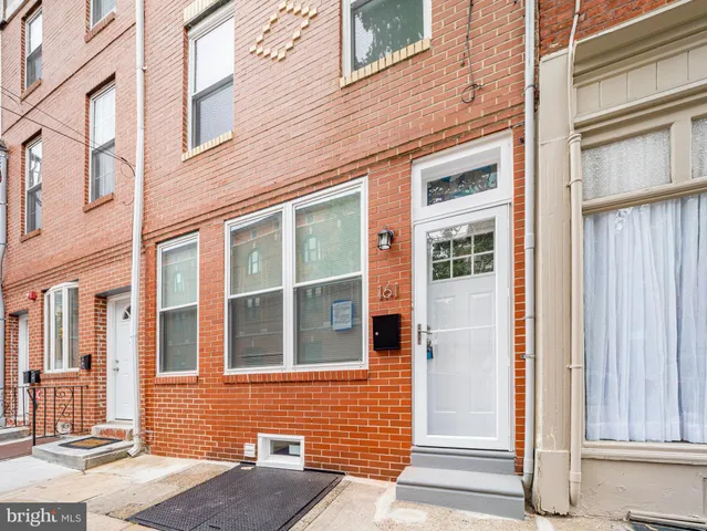 a view of a brick house with a large window