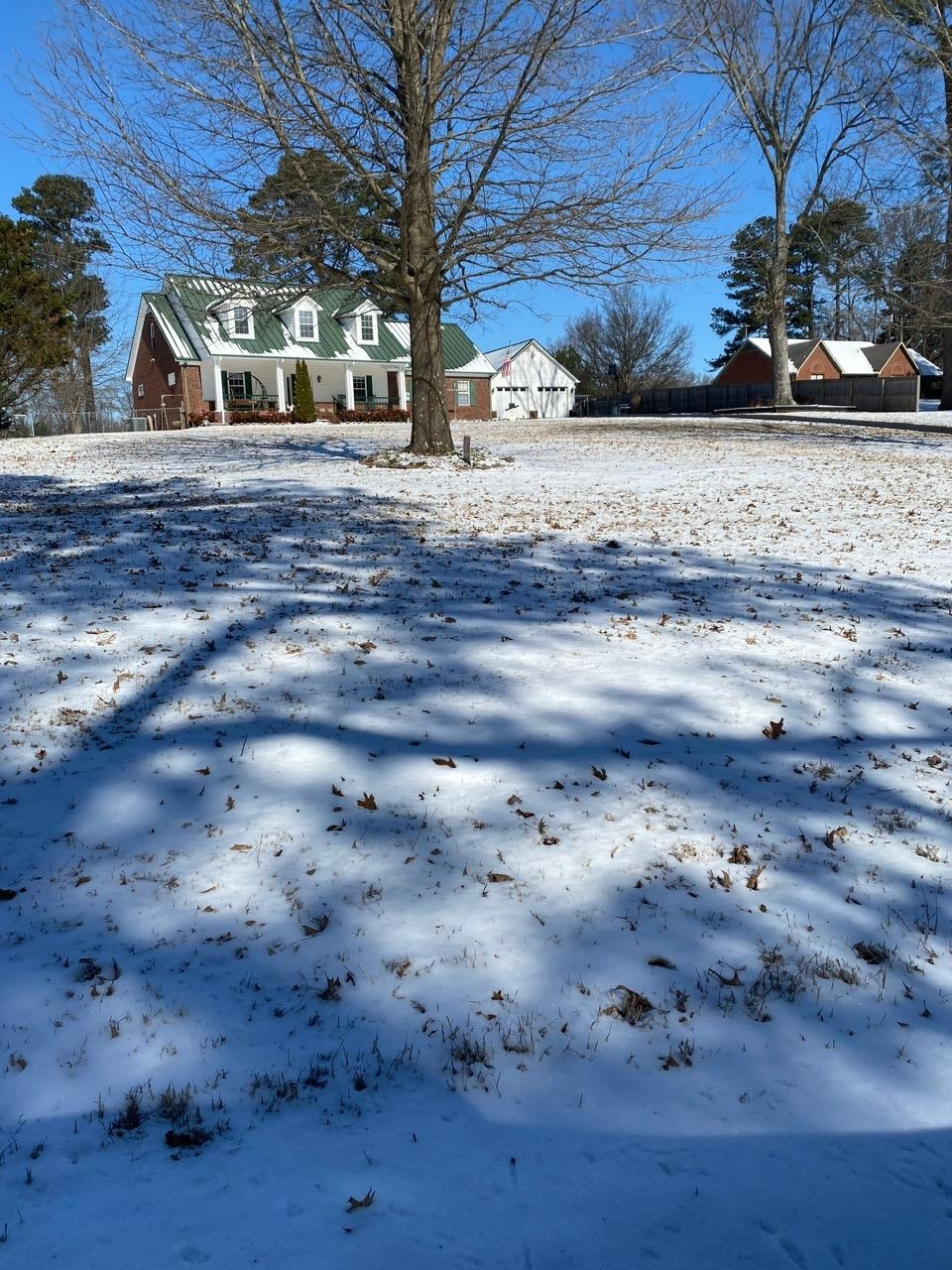 698 Reed Circle Drummonds, TN 38023 - Photo 1 of 26 Snowy yard featuring a detached garage and a residential view