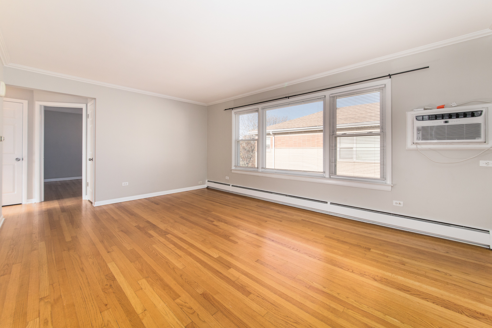 2245 Des Plaines Avenue, Unit B North Riverside, IL 60546 - Photo 3 of 22 an empty room with wooden floor and windows