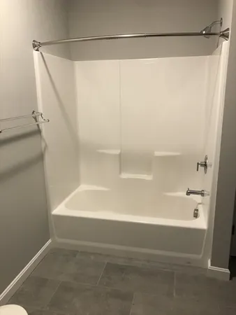 a bathroom with a shower and a bath tub