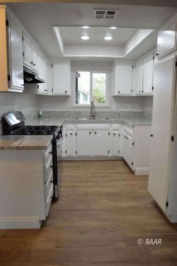 542 North Rio Bravo Street Ridgecrest, CA 93555 - Photo 2 of 11 a kitchen with granite countertop a stove and a sink