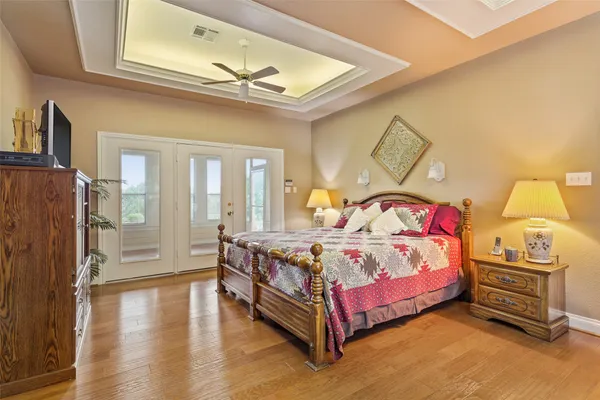 a bedroom with a bed and wooden floor