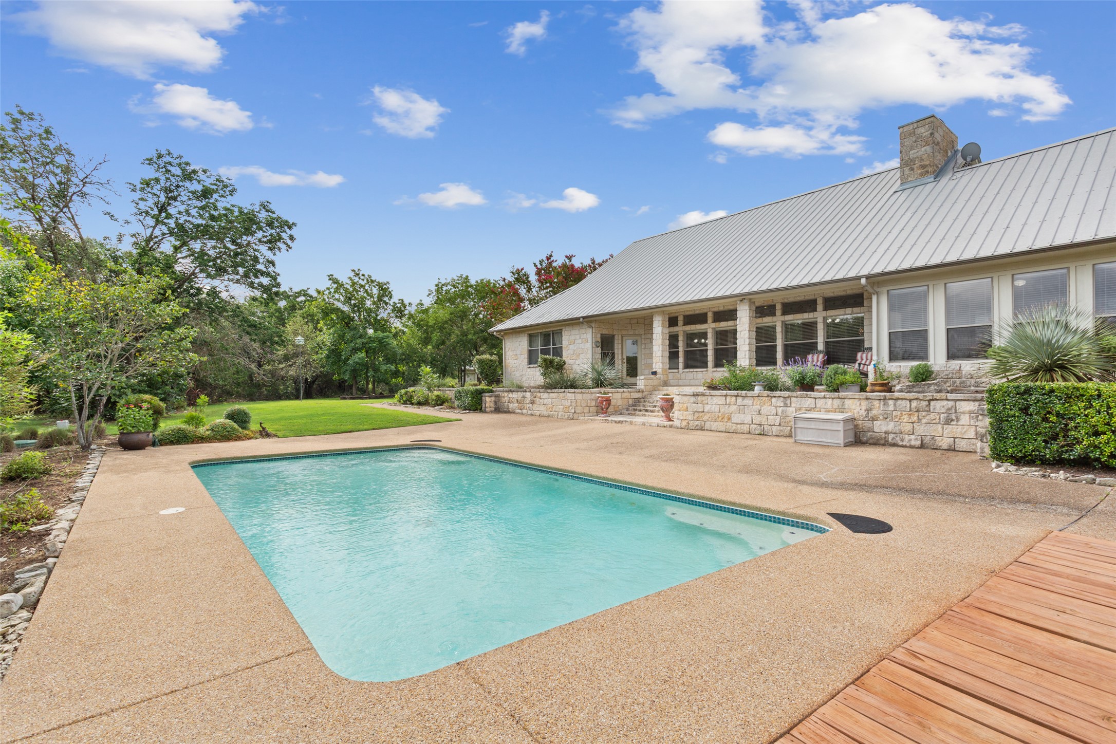 13730 Settlements Road Salado, TX 76571 - Photo 19 of 40 a view of a swimming pool with lawn chairs and plants