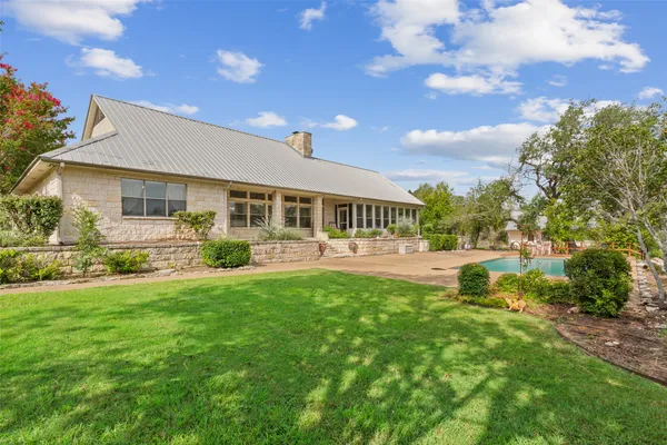 a view of a house with a yard porch and sitting area
