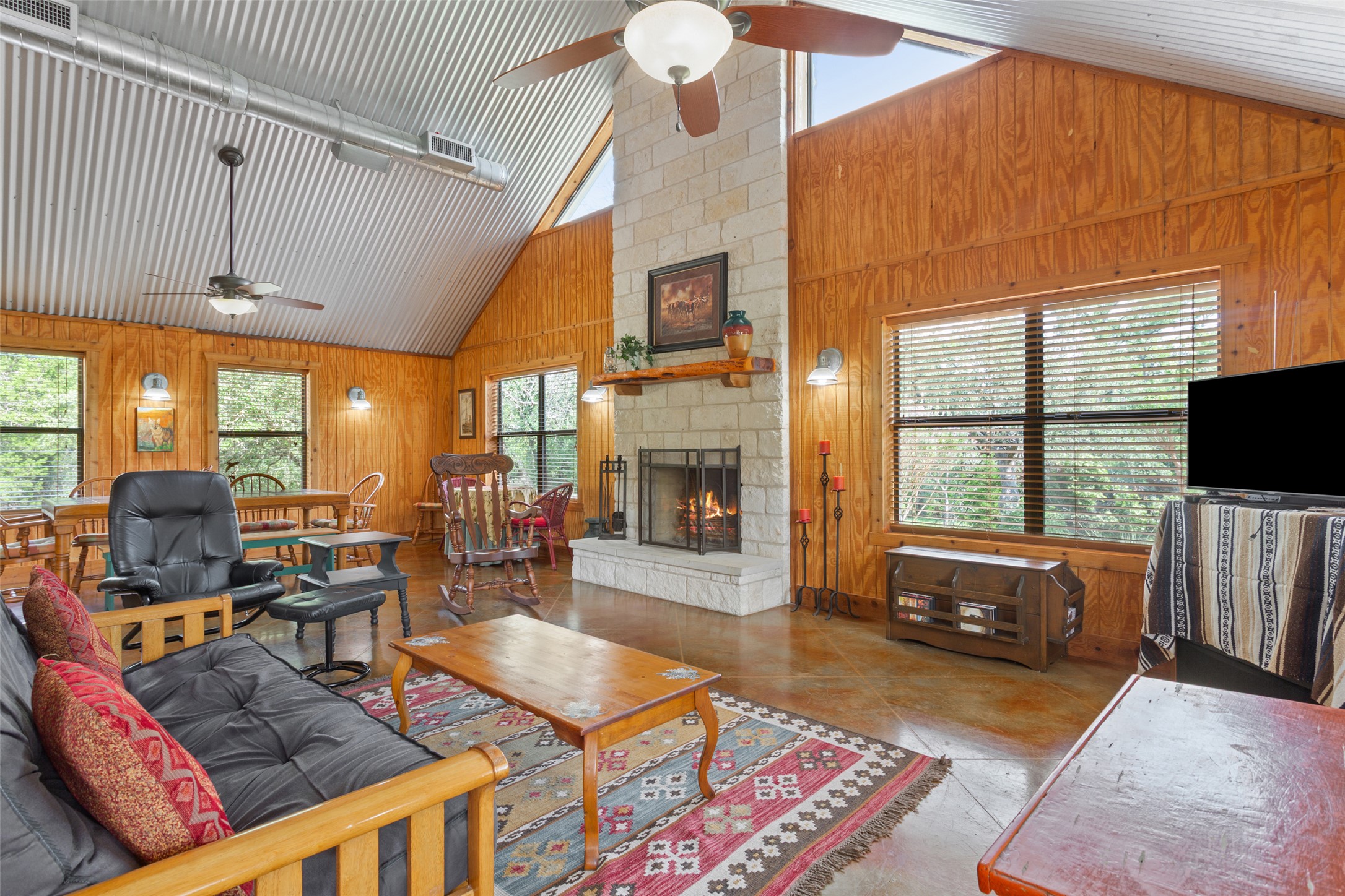 13730 Settlements Road Salado, TX 76571 - Photo 24 of 40 a living room with furniture a flat screen tv and floor to ceiling window