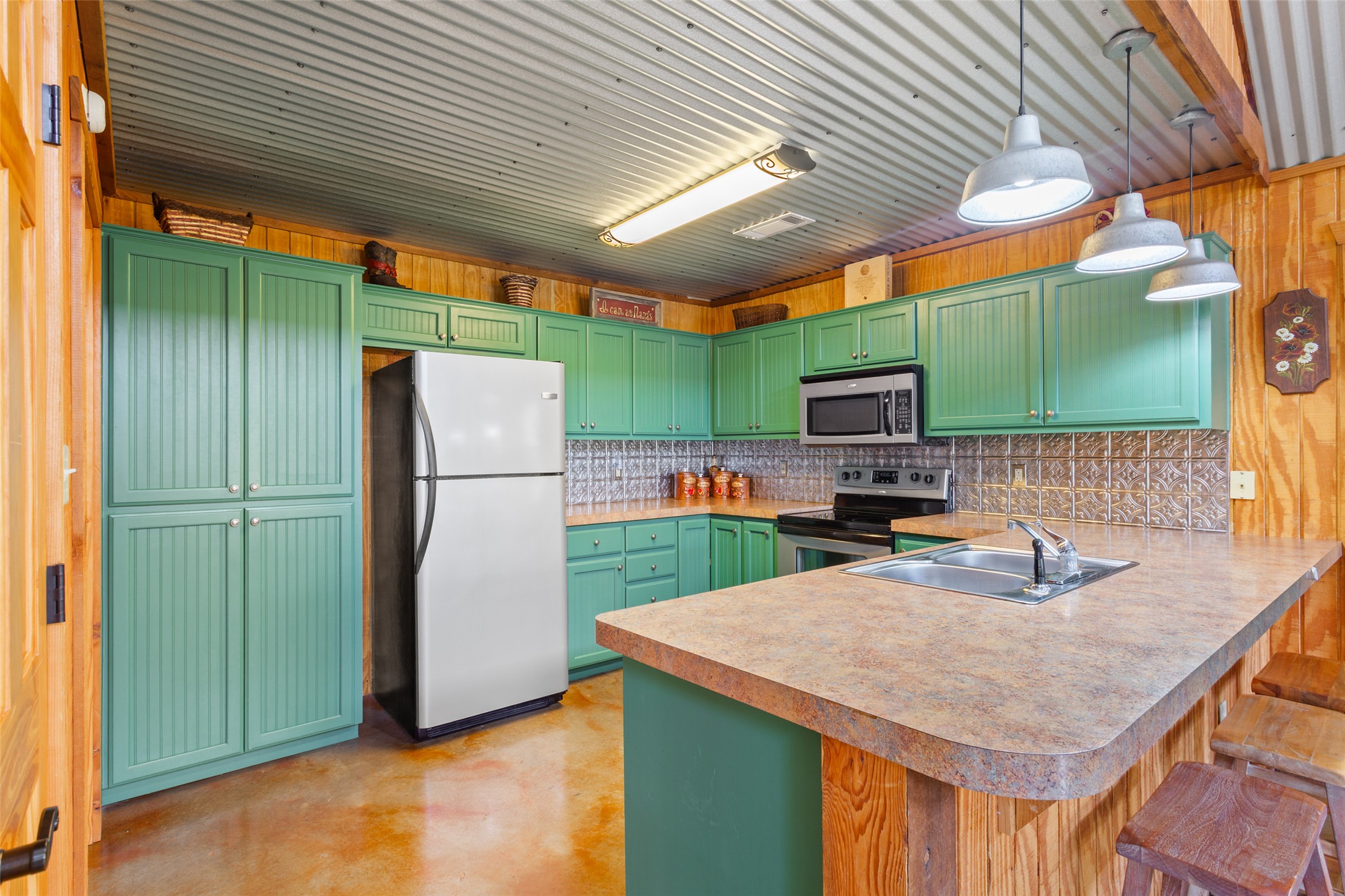 13730 Settlements Road Salado, TX 76571 - Photo 27 of 40 a kitchen with stainless steel appliances granite countertop a refrigerator a sink and a stove