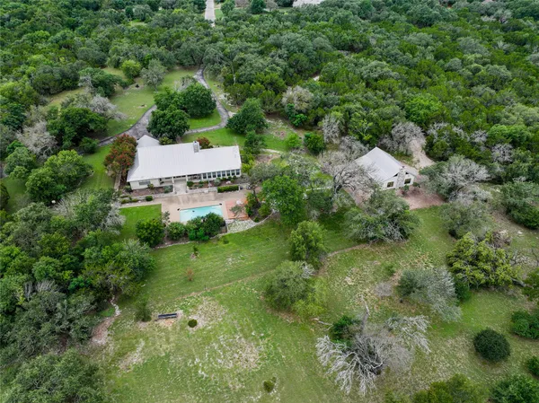 an aerial view of a house with a yard