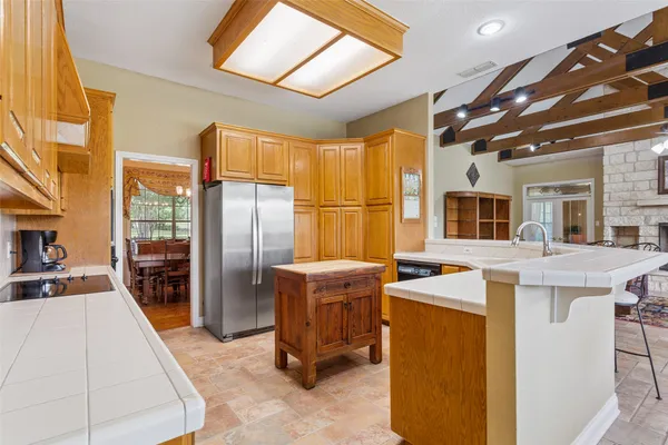 a kitchen that has a lot of cabinets in it and appliances