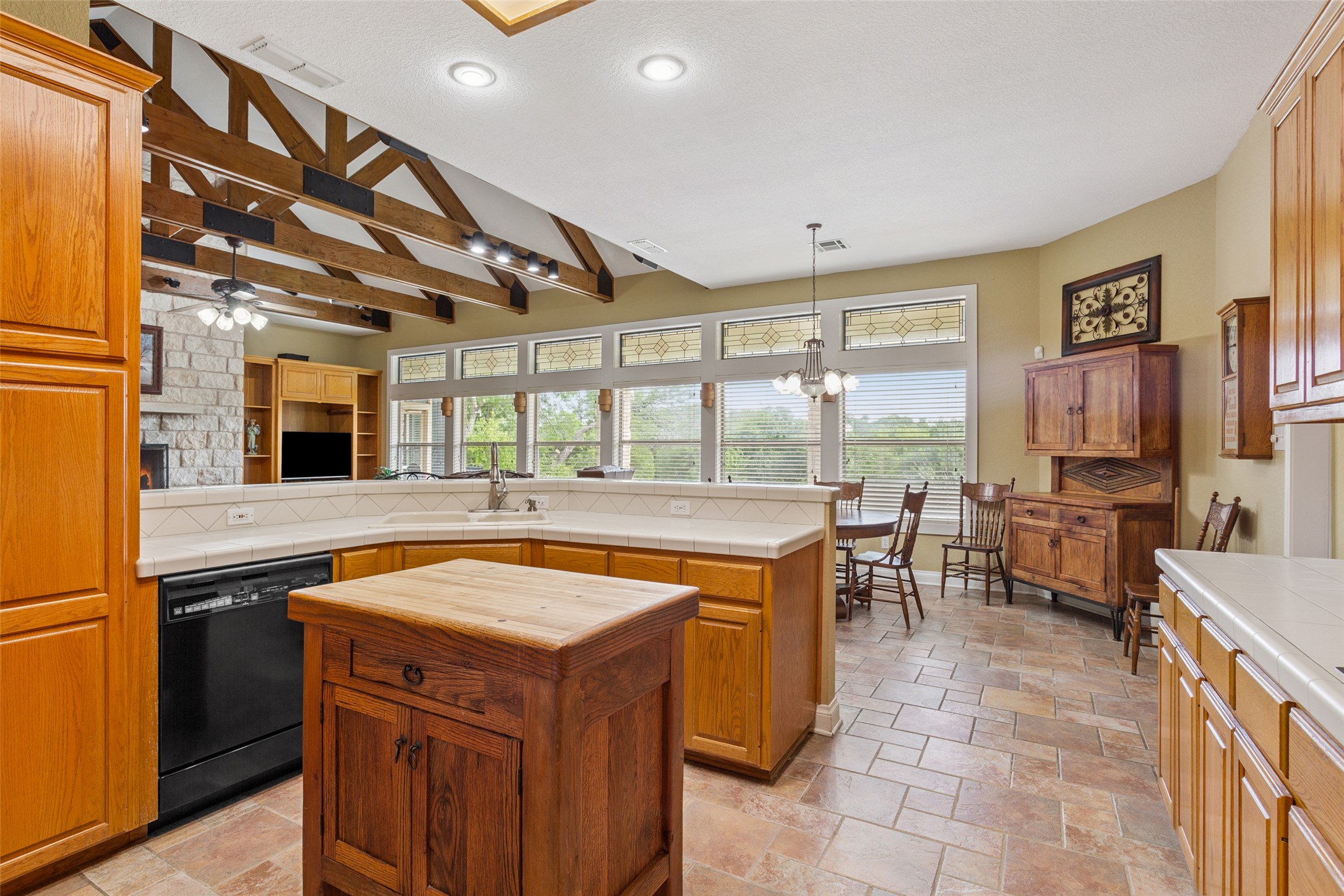 13730 Settlements Road Salado, TX 76571 - Photo 10 of 40 a kitchen with a stove a sink dishwasher and a dining table with the kitchen view