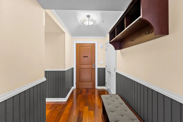 a view of a hallway with wooden floor