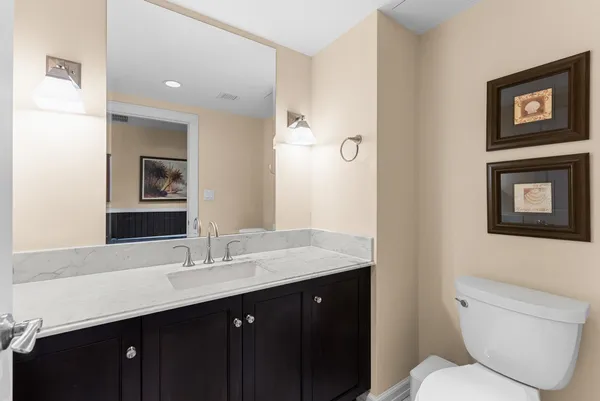 a bathroom with a toilet a sink a mirror and a shower