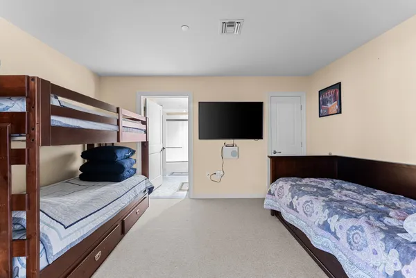 a bedroom with a bed and a television