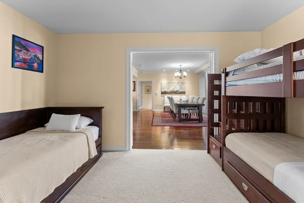 a bed room with a bed and a view of kitchen