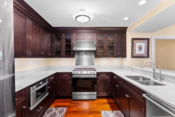 a kitchen with granite countertop a stove and a sink