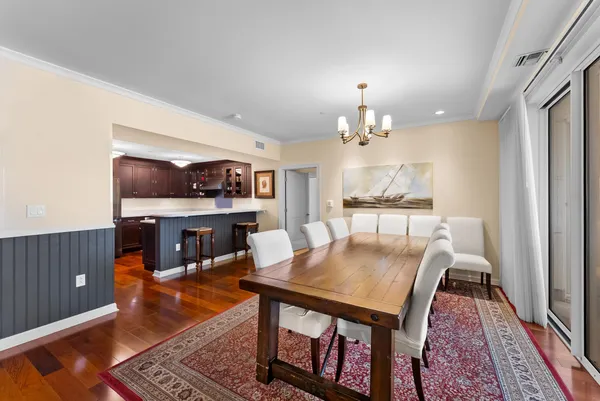 a view of a dining room with furniture and a chandelier