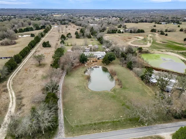an aerial view of residential houses with outdoor space