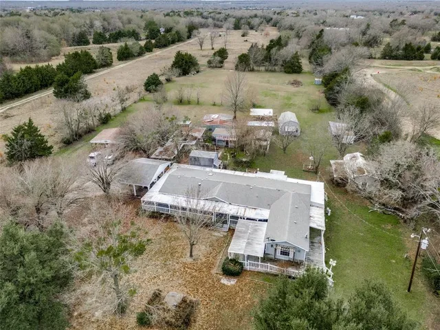 an aerial view of a house with a yard