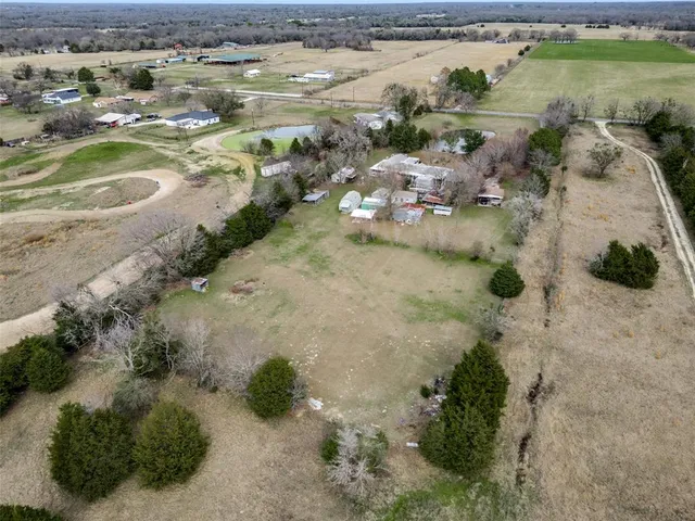 an aerial view of ocean beach and residential house with outdoor space