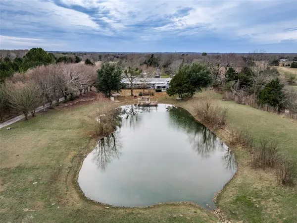 a view of a lake in middle of the forest