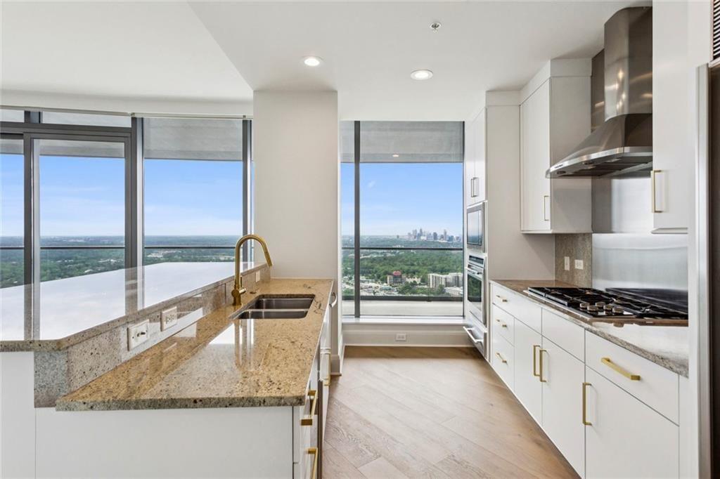 3344 Peachtree Road Northeast, Unit 4104 Atlanta, GA 30326 - Photo 6 of 30 a kitchen with stainless steel appliances granite countertop a stove and a sink