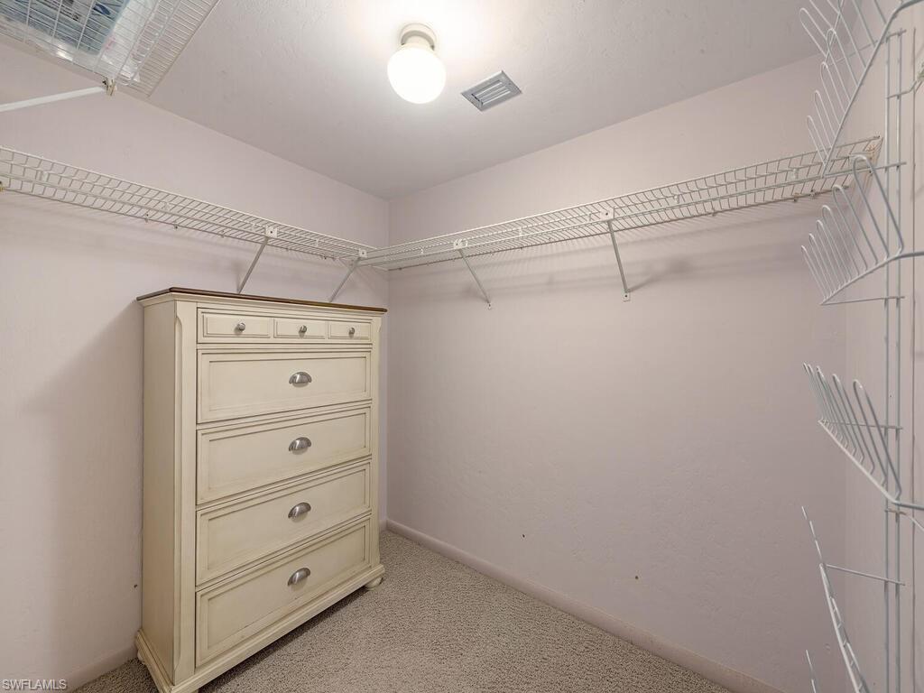 5590 Rattlesnake Hammock Road, Unit M203 Naples, FL 34113 - Photo 12 of 22 a view of an empty walk in closet