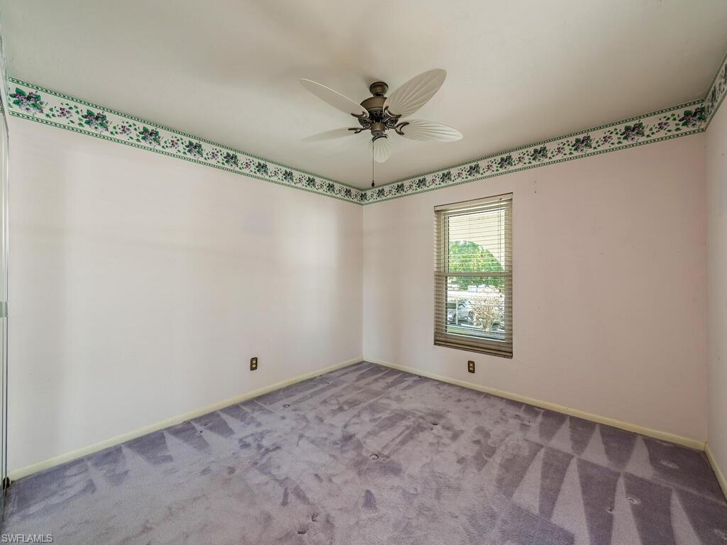 5590 Rattlesnake Hammock Road, Unit M203 Naples, FL 34113 - Photo 13 of 22 a view of a room with a window and a ceiling fan
