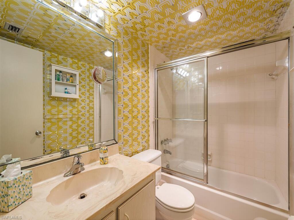 5590 Rattlesnake Hammock Road, Unit M203 Naples, FL 34113 - Photo 14 of 22 a bathroom with a sink a toilet and shower