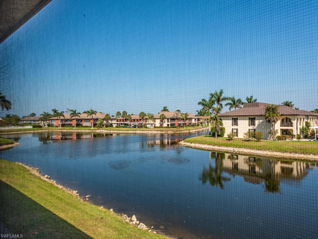 5590 Rattlesnake Hammock Road, Unit M203 Naples, FL 34113 - Photo 17 of 22 a view of a lake with houses