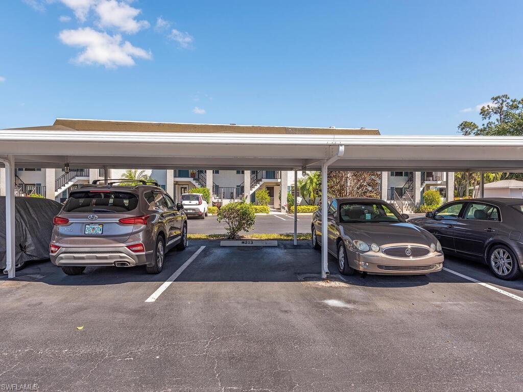 5590 Rattlesnake Hammock Road, Unit M203 Naples, FL 34113 - Photo 18 of 22 a car parked in garage