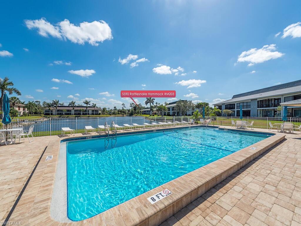 5590 Rattlesnake Hammock Road, Unit M203 Naples, FL 34113 - Photo 19 of 22 a view of swimming pool from a balcony