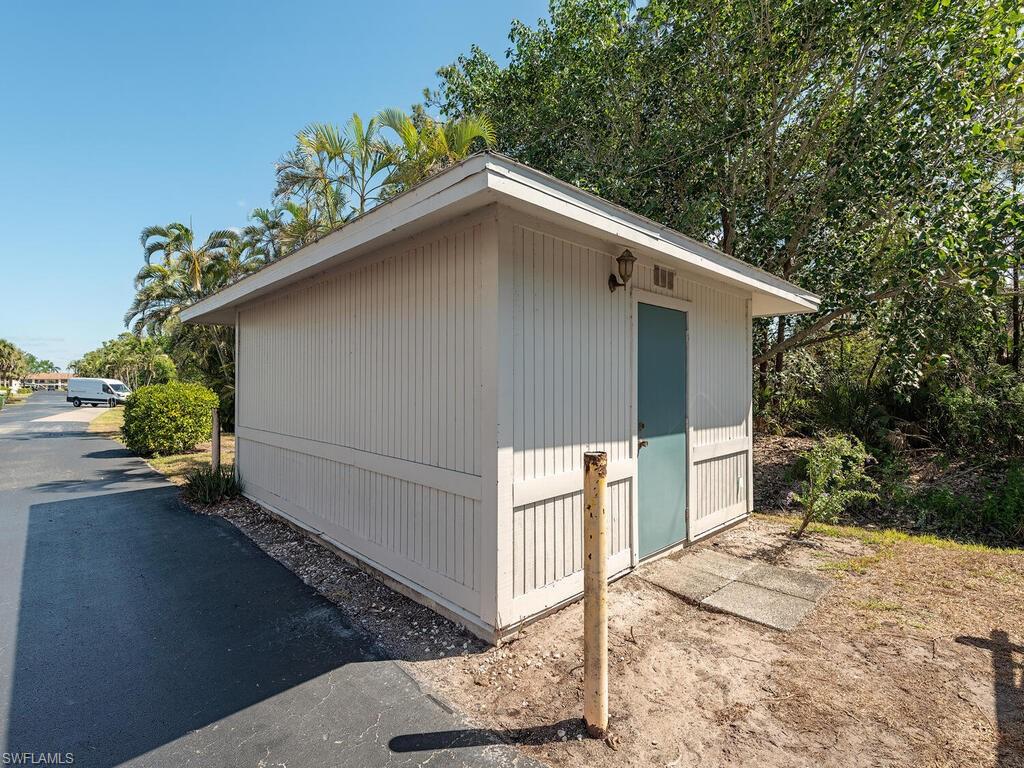 5590 Rattlesnake Hammock Road, Unit M203 Naples, FL 34113 - Photo 21 of 22 a backyard of a house with lots of green space