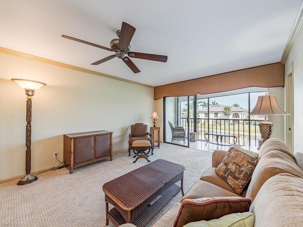 5590 Rattlesnake Hammock Road, Unit M203 Naples, FL 34113 - Photo 3 of 22 a living room with furniture a ceiling fan and a window