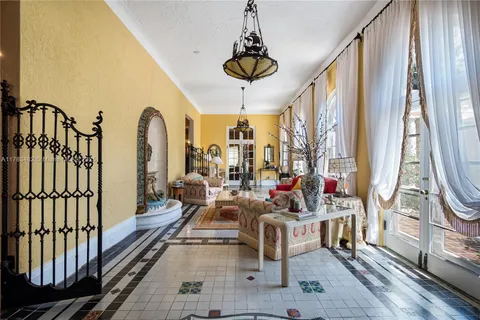 a living room with fireplace furniture and a large window